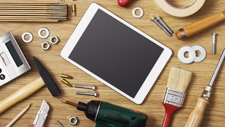 Tablet og værktøj på skrivebord