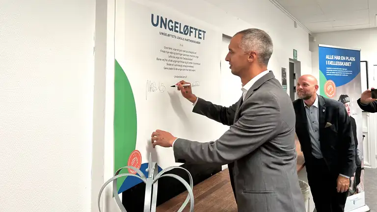 Undervisningsminister Mattias Tesfaye skriver på tavle